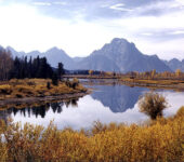 Mountains reflected in a riverbend.